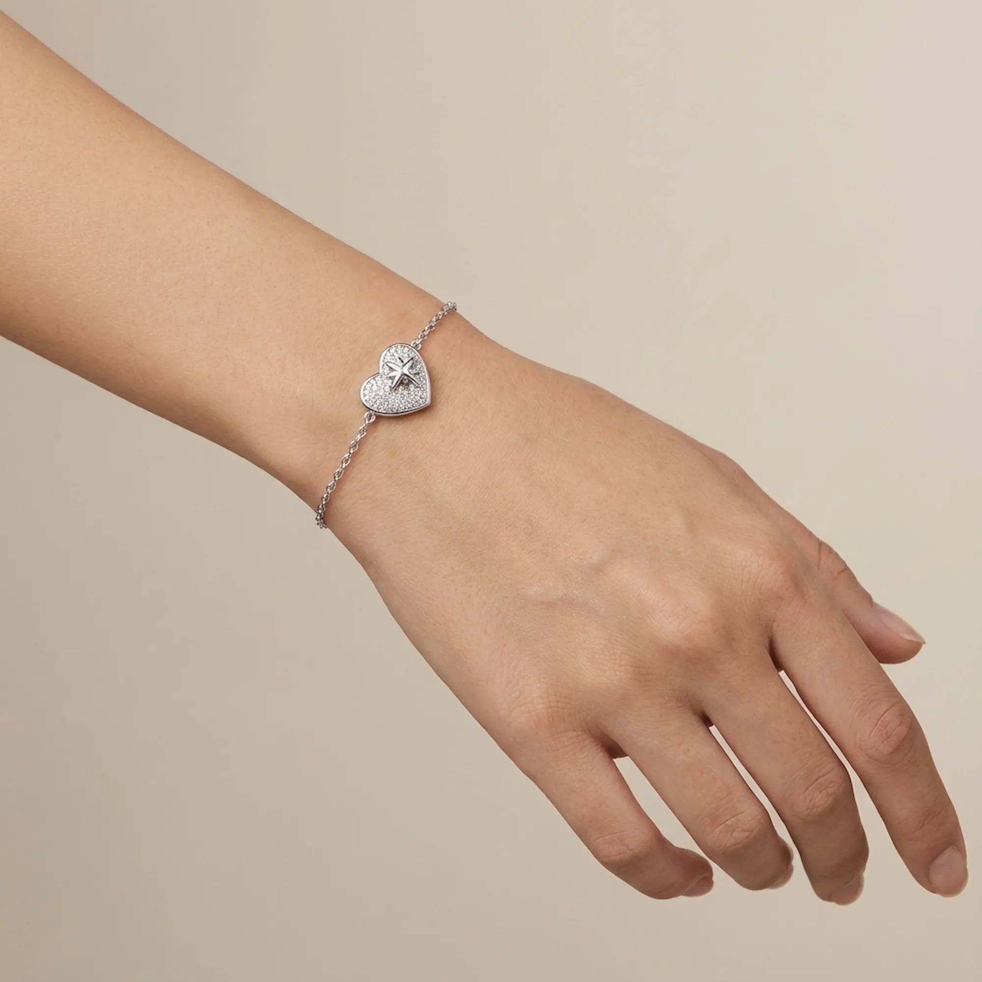 North Star pavé CZ heart bracelet worn on wrist showing 15cm fit and stationed heart charm — rhodium 925 silver Dubai