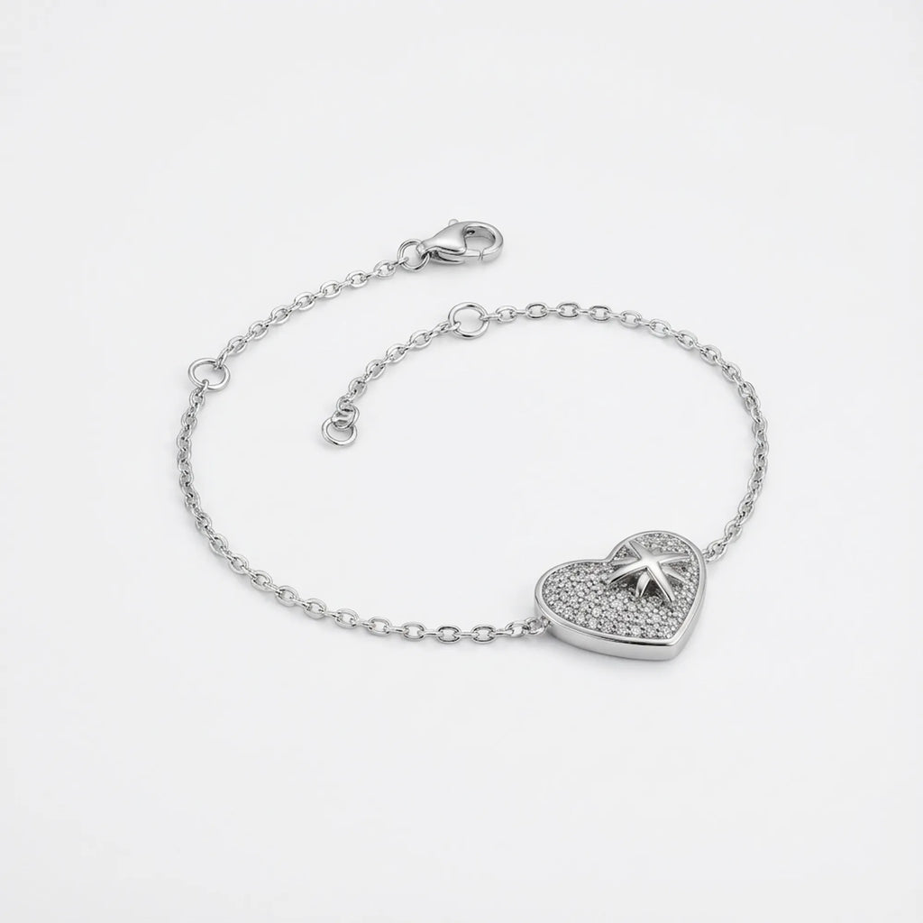 North Star pavé heart bracelet in rhodium 925 sterling silver — lobster clasp, 4cm extender chain and CZ heart charm on neutral background