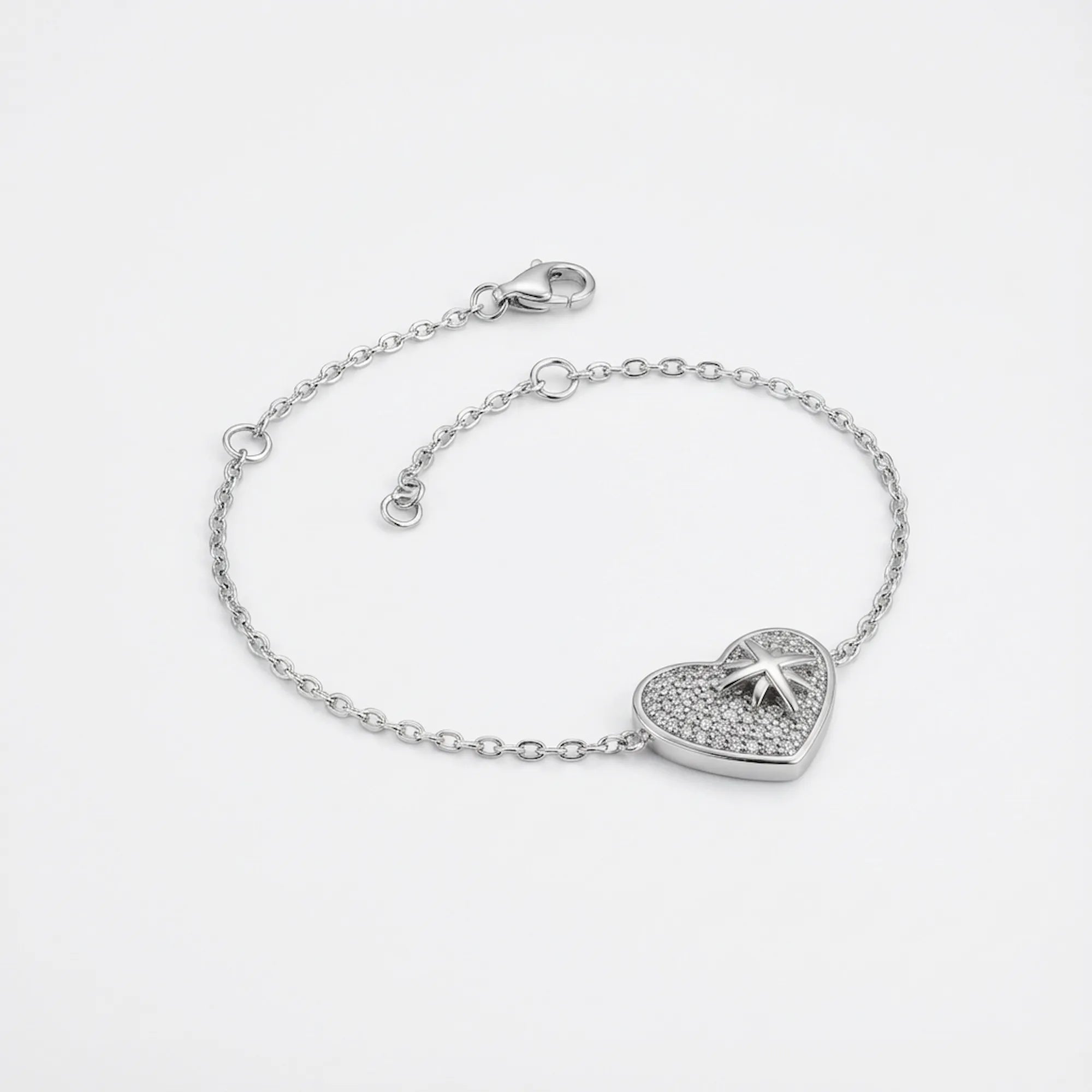 North Star pavé heart bracelet in rhodium 925 sterling silver — lobster clasp, 4cm extender chain and CZ heart charm on neutral background