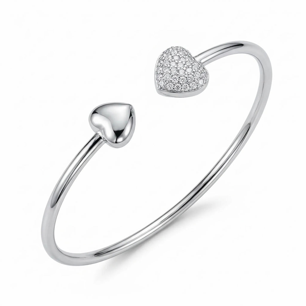 Close up of the matching 925 silver open cuff bangle showcasing the detailed cubic zirconia pave heart and plain silver locket ends.