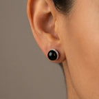 Black orbital stud earring with cubic zirconia halo worn on the ear, 925 sterling silver, Dubai UAE