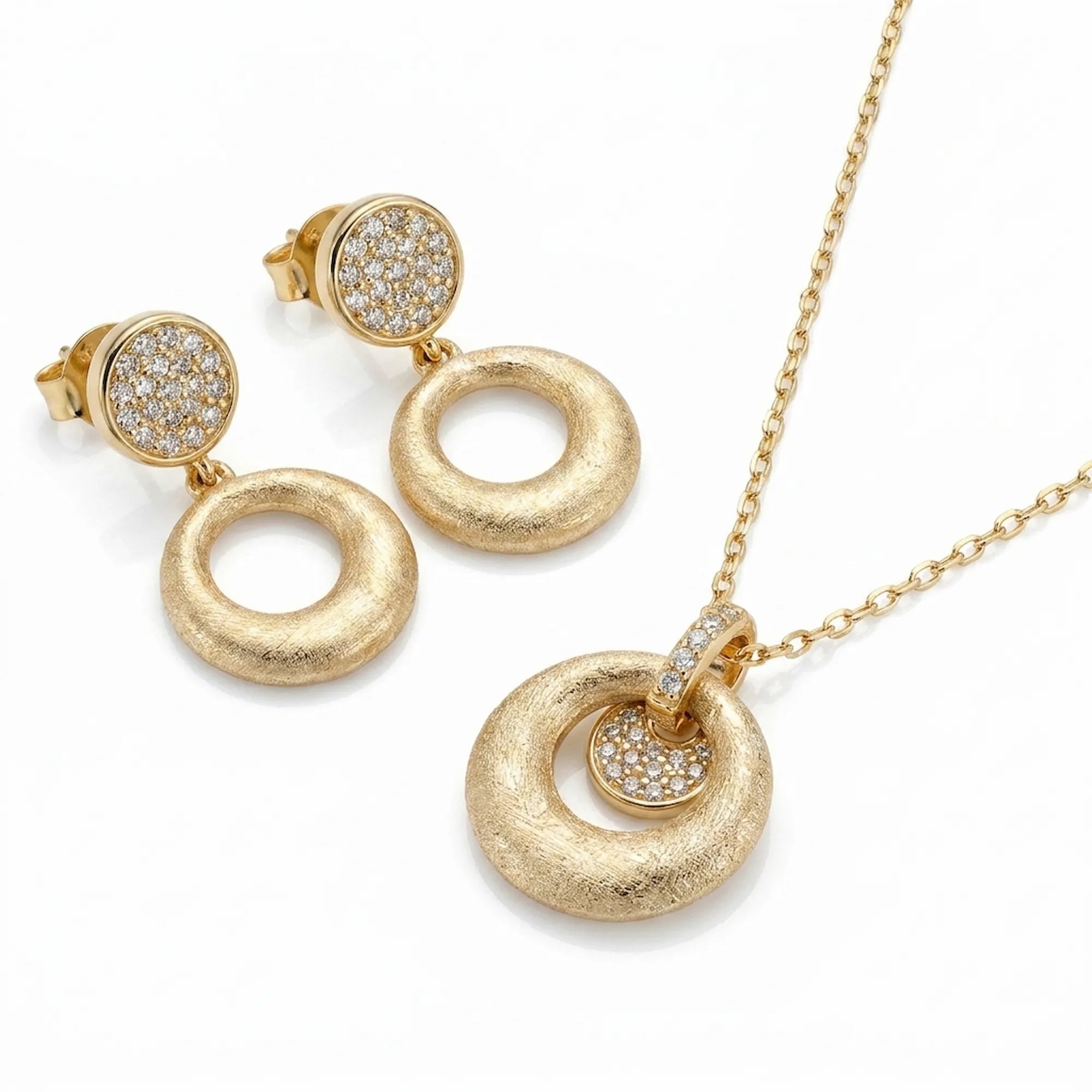 Brushed 18K gold orbiting disc pendant necklace and circle drop earrings in 925 sterling silver — white background