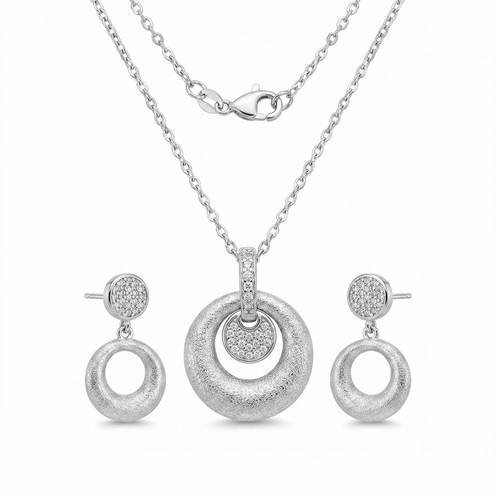 Brushed rhodium silver orbiting disc pendant necklace and circle drop earrings — 925 sterling silver set white background