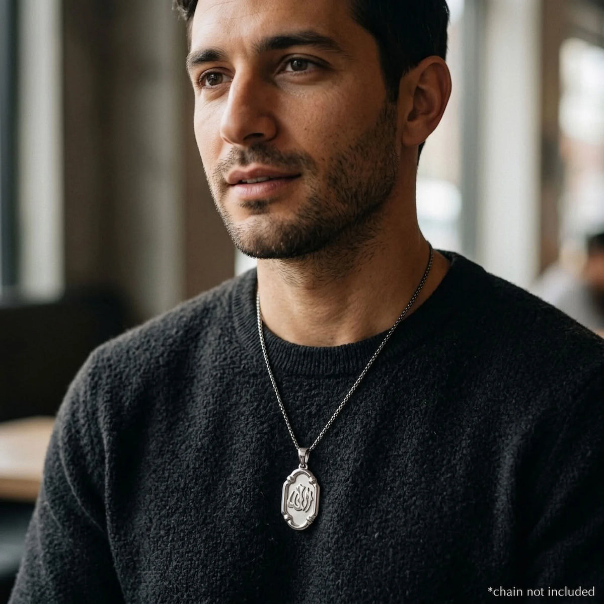 Man wearing an oval Allah sterling silver pendant on a styling chain, which is not included.