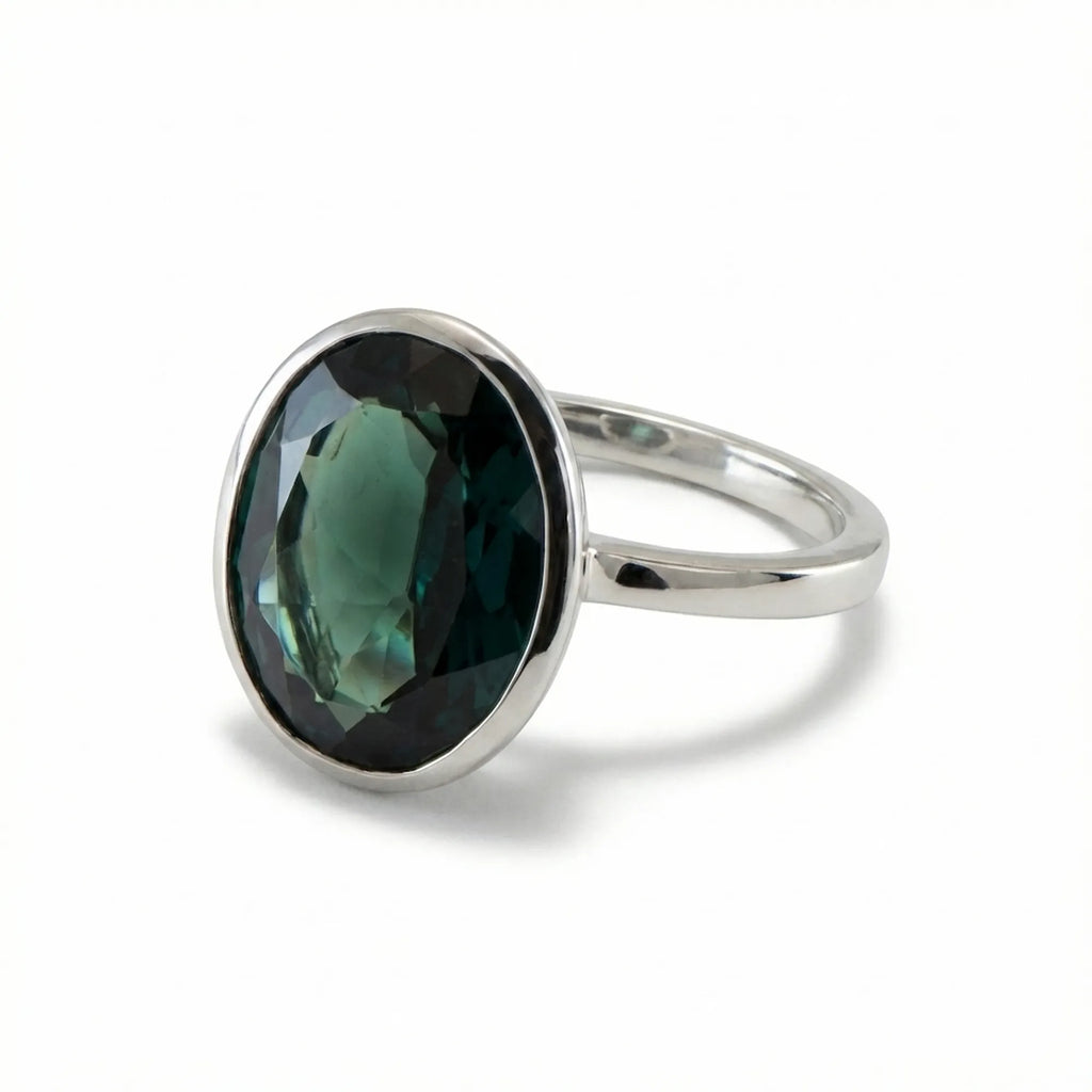 Angled view of the elegant November birthstone jewelry showing the smooth 925 sterling silver bezel protecting the London Blue Topaz.