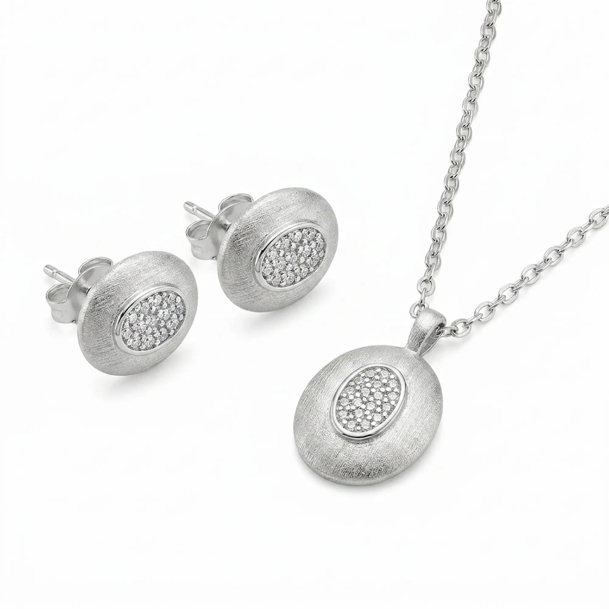 Brushed rhodium oval pendant necklace and matching CZ pavé stud earrings in 925 sterling silver — white background