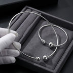 Close up detail of the solid 925 silver and pave cz spheres on the sterling silver choker resting in a plush display box.
