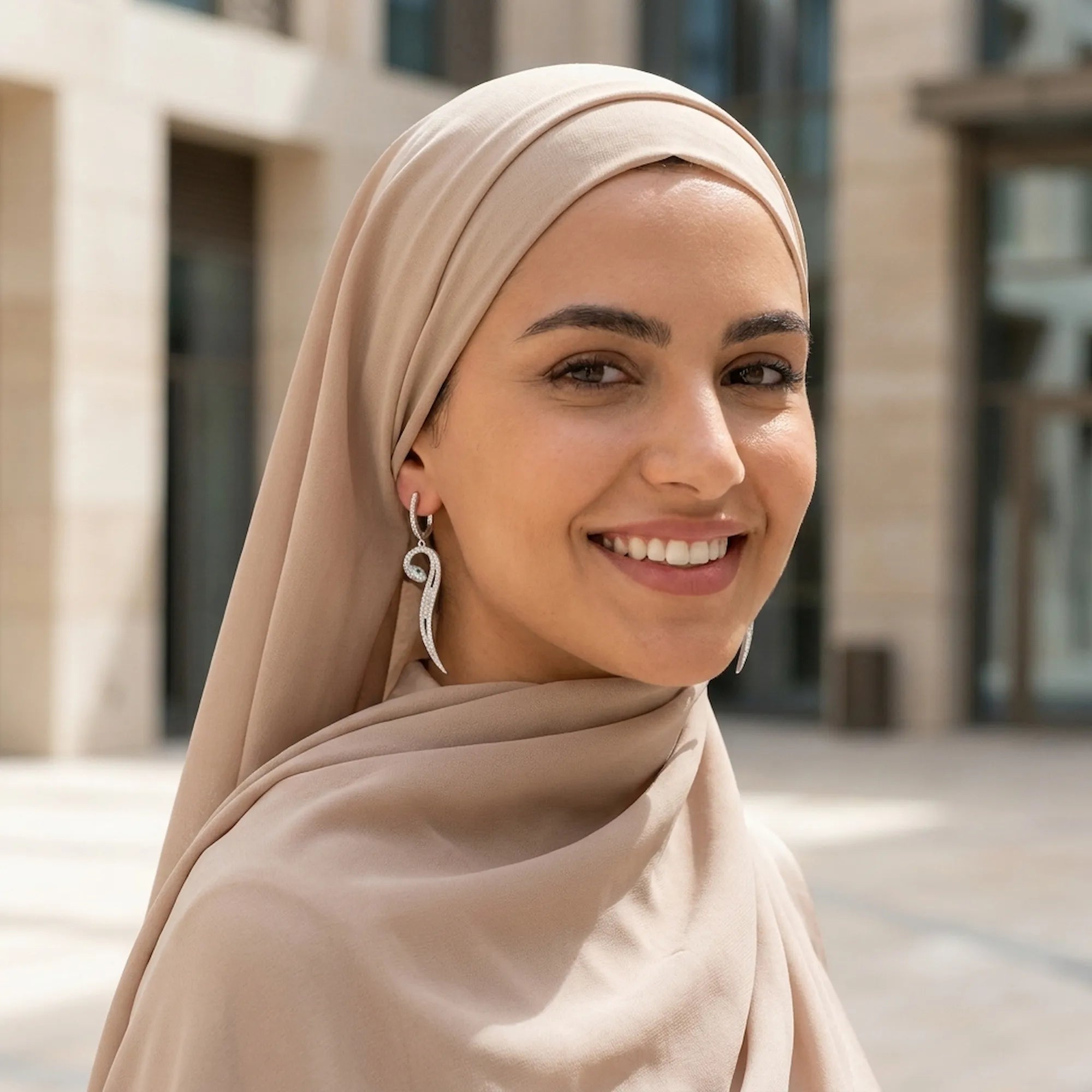 Paved serpent drop earrings on hijab model outdoors — Dubai modern setting, 925 silver CZ statement drop earring