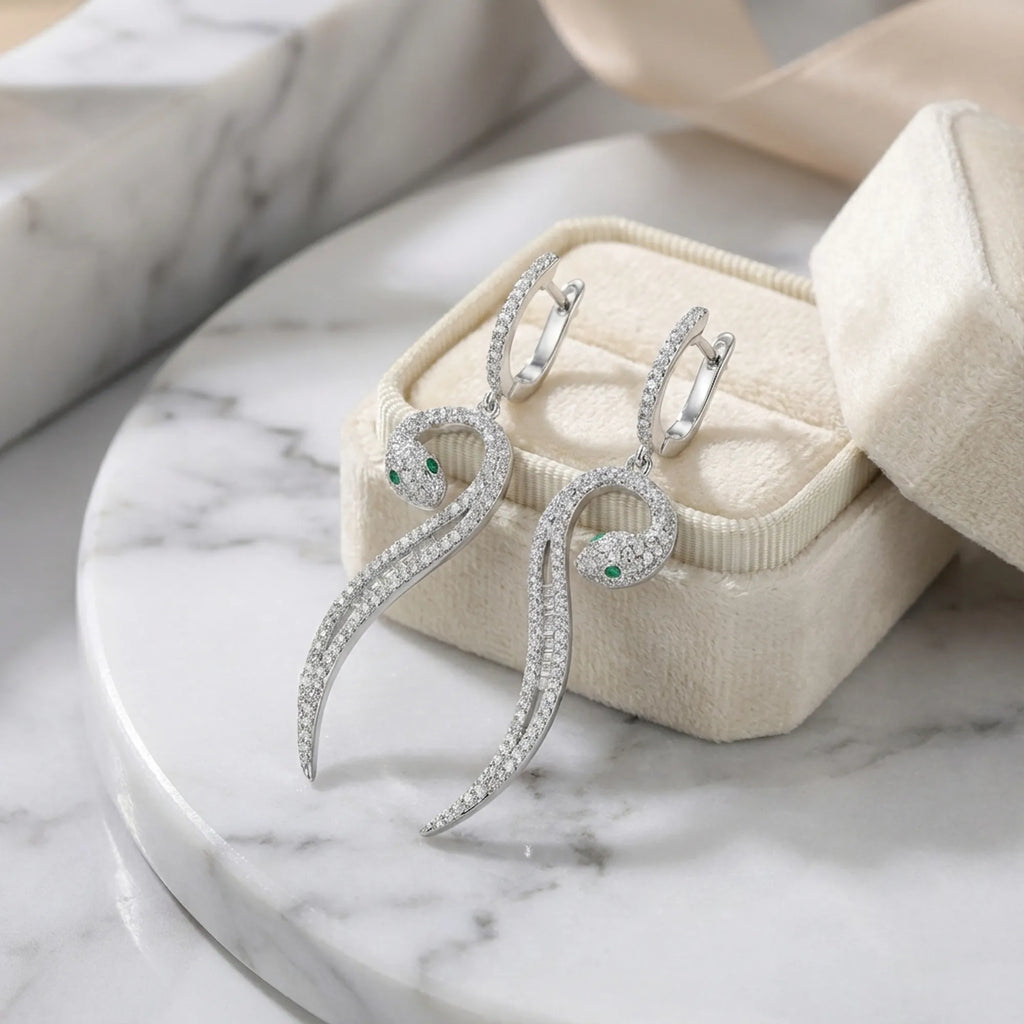 Paved serpent drop earrings in cream jewelry box on marble — rhodium 925 silver CZ, gift-ready presentation