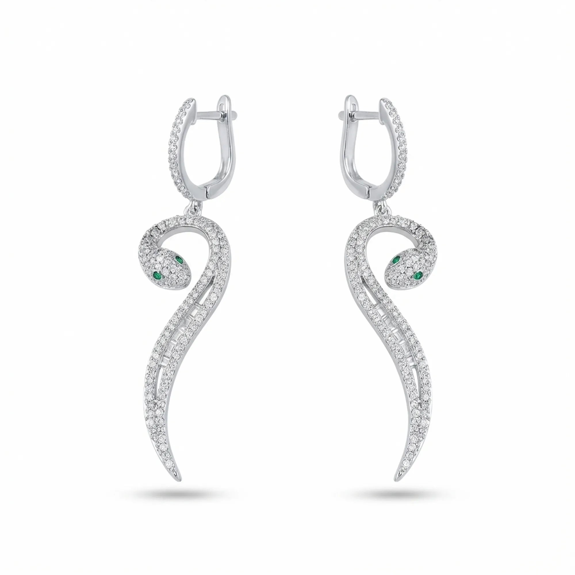 Paved serpent drop earrings in rhodium 925 silver — green CZ eye, mixed round and baguette cubic zirconia, white background