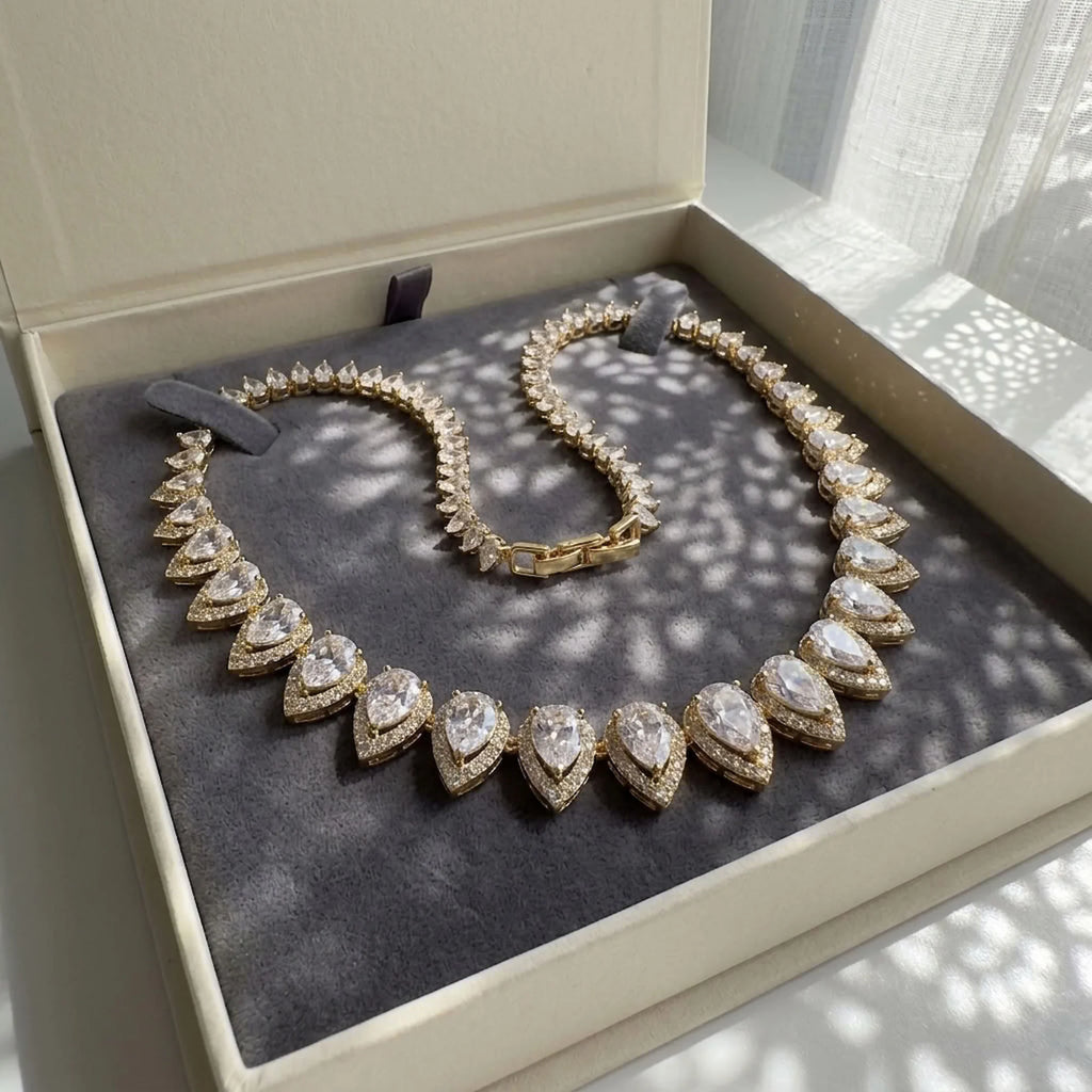 18k gold-plated bridal choker with graduated pear-cut cubic zirconia displayed in a jewelry box in Dubai.