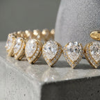 Macro view of graduated pear-cut cubic zirconia and pave halos on an 18k gold-plated bridal choker in Dubai.