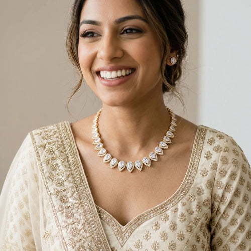 Woman wearing an 18k gold-plated bridal choker with graduated pear-cut cubic zirconia indoors in Dubai.