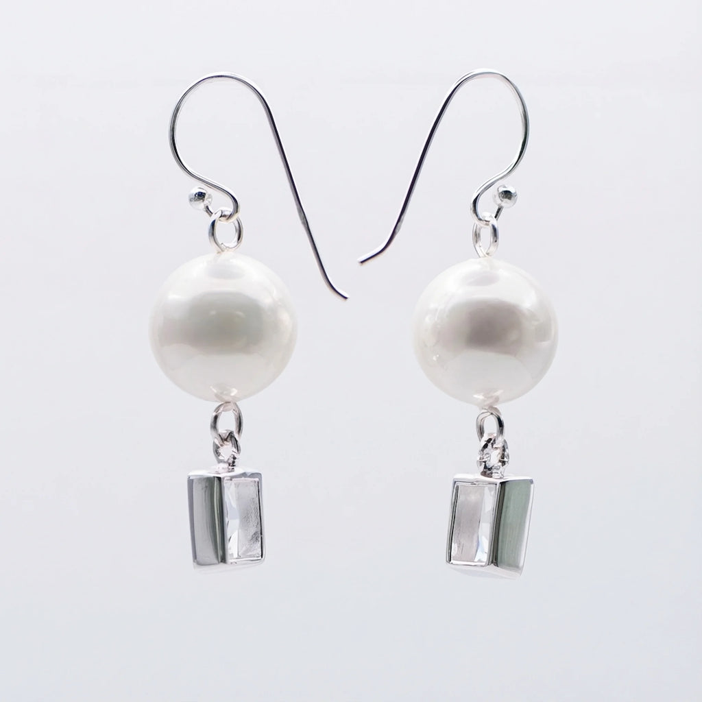 Two silver pearl drop earrings with rectangular cubic zirconia and shepherd hooks