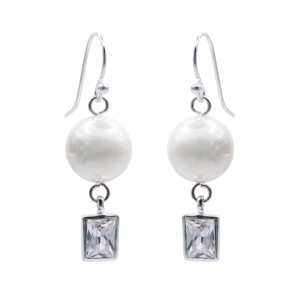 Pair of silver pearl drop earrings with bezel-set rectangular cubic zirconia on white