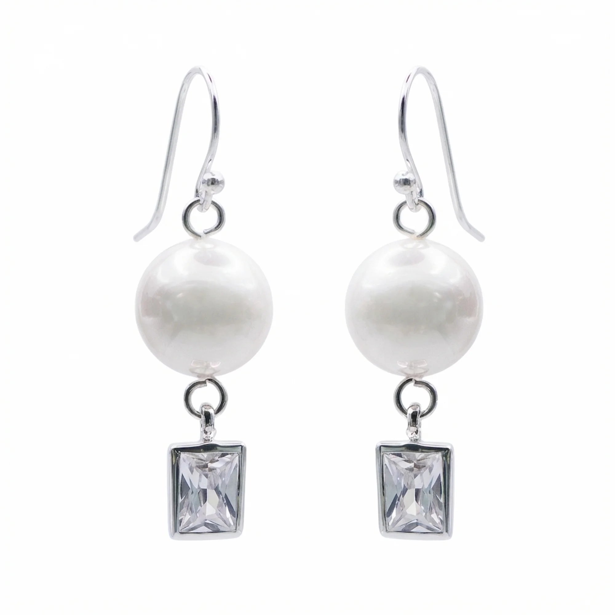 Pair of silver pearl drop earrings with bezel-set rectangular cubic zirconia on white