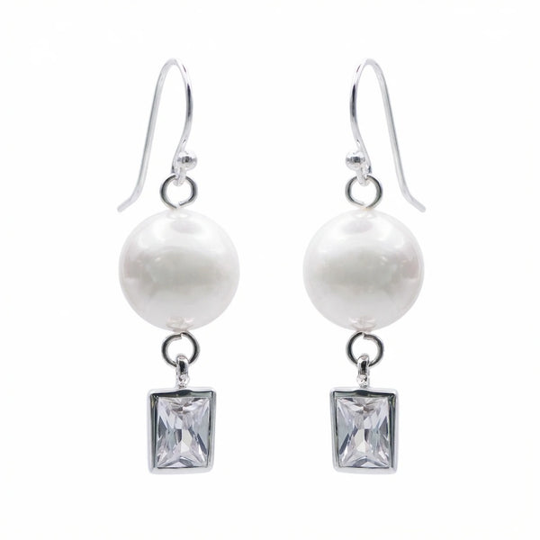 Pair of silver pearl drop earrings with bezel-set rectangular cubic zirconia on white
