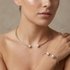 Female model wearing the fresh water pearl choker and matching 55mm snug fit bangle to demonstrate the elegant scale and proportional fit.