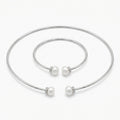 Front view of the Luna Dura pearl necklace set in 925 sterling silver in dubai featuring a torque choker and matching bangle with fresh water pearls.