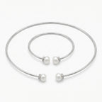 Front view of the Luna Dura pearl necklace set in 925 sterling silver featuring a torque choker and matching bangle with fresh water pearls.