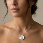 925 silver pearl vortex pendant worn at bare neckline on diamond-cut bead chain, showing scale