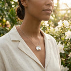 Pearl vortex pendant necklace by Luna Dura Dubai, worn over cream linen collar in natural light