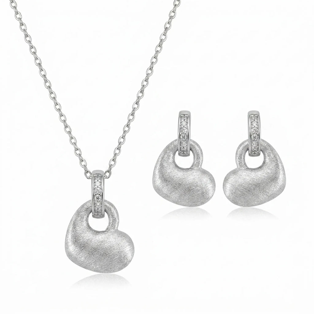 Brushed rhodium silver puffed heart pendant necklace and drop earrings in 925 sterling silver — white background