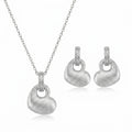 Brushed rhodium silver puffed heart in Dubai pendant necklace and drop earrings in 925 sterling silver — white background.