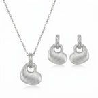 Brushed rhodium silver puffed heart pendant necklace and drop earrings in 925 sterling silver — white background
