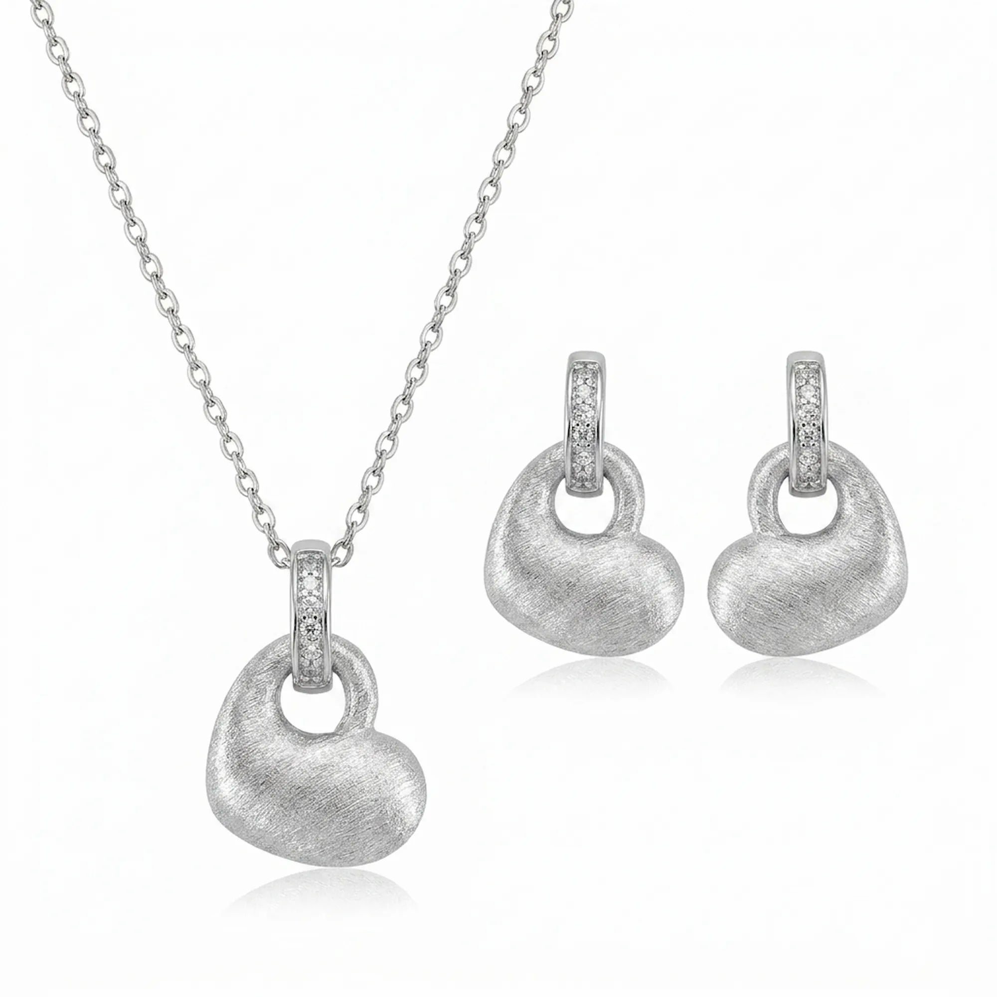 Brushed rhodium silver puffed heart pendant necklace and drop earrings in 925 sterling silver — white background