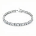 Round-cut white cubic zirconia tennis bracelet in a rhodium-plated copper setting, shown with an open box clasp in Dubai.