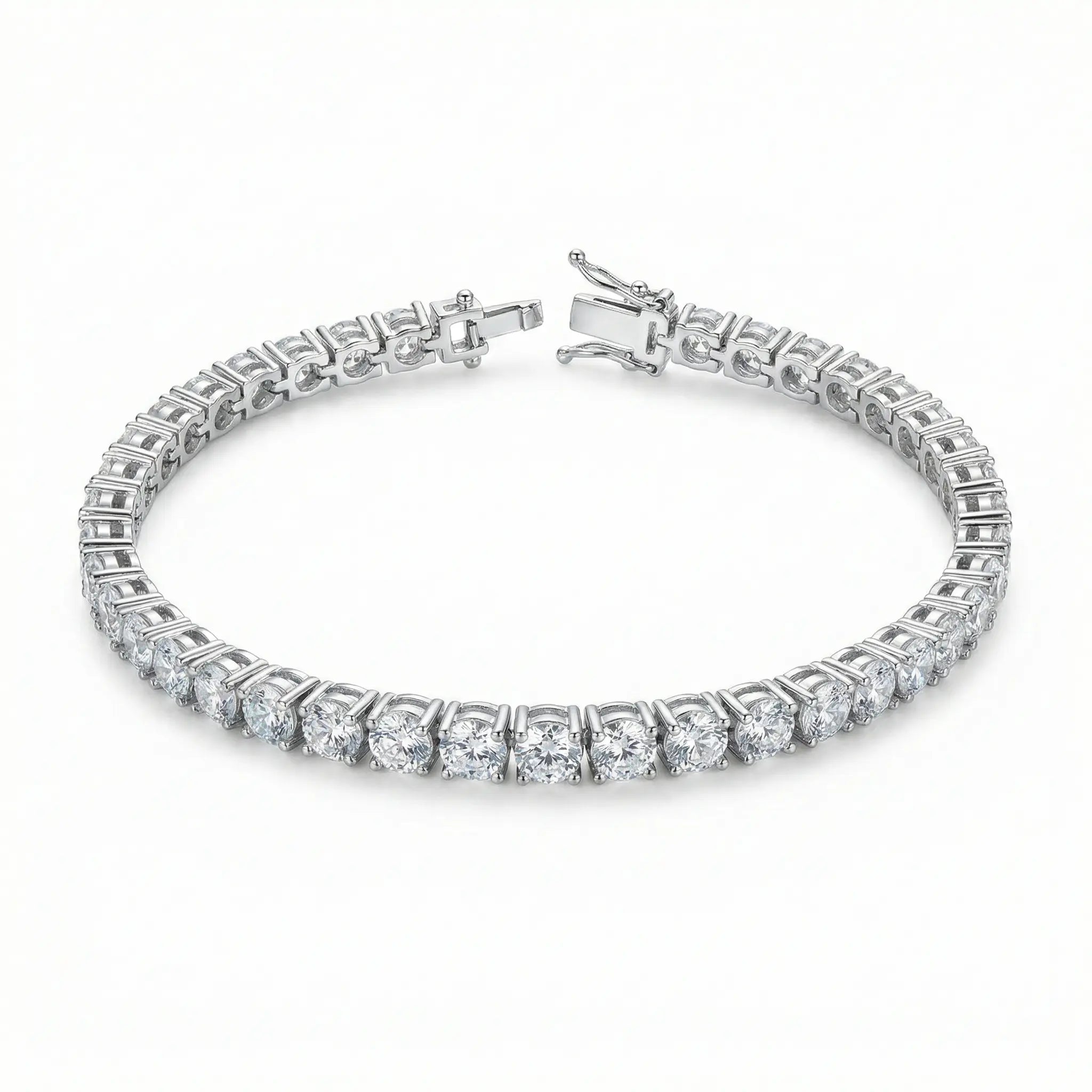 Round-cut white cubic zirconia tennis bracelet in a rhodium-plated copper setting, shown with an open box clasp on a white background