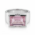 Rose quartz emerald cut statement ring, 925 sterling silver half bezel setting, angled view, white background in Dubai.
