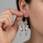 Easily securing the comfortable shepherd hook closure of these 925 sterling silver leaf chain drop earrings featuring snow quartz stones.