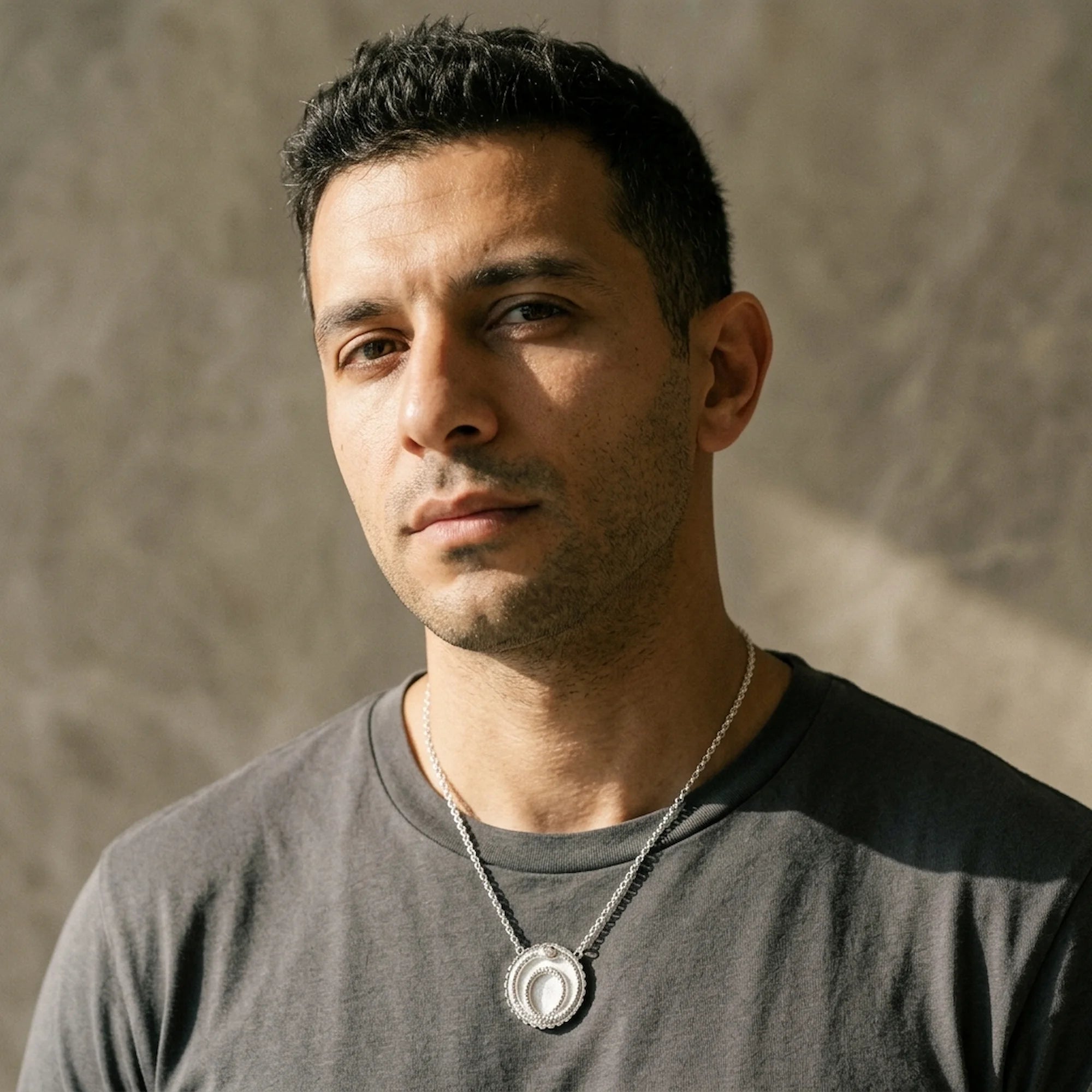 Man wearing the unisex ivory silver enamel ouroboros snake necklace in 925 sterling silver, an everyday talisman in Dubai.
