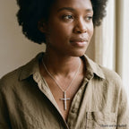 Woman wearing a mirror-polished sterling silver crucifix pendant with raised Corpus, chain not included.