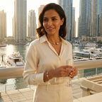 Beautiful woman wearing the minimalist sterling silver choker and matching bangle while standing by the Dubai marina at sunset.