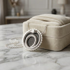 Charcoal silver enamel ouroboros snake necklace in 925 sterling silver resting against a jewellery box in Dubai.