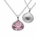 Reversible 925 silver lab-grown pink sapphire lotus pendant necklace showing front and sunburst back, hand made in Dubai.
