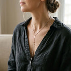 Woman wearing Italian sterling silver lariat necklace with geometric beaded Y-drop.