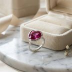 Vivid magenta quartz lotus cocktail ring in 925 sterling silver resting beside a velvet jewellery box in Dubai.