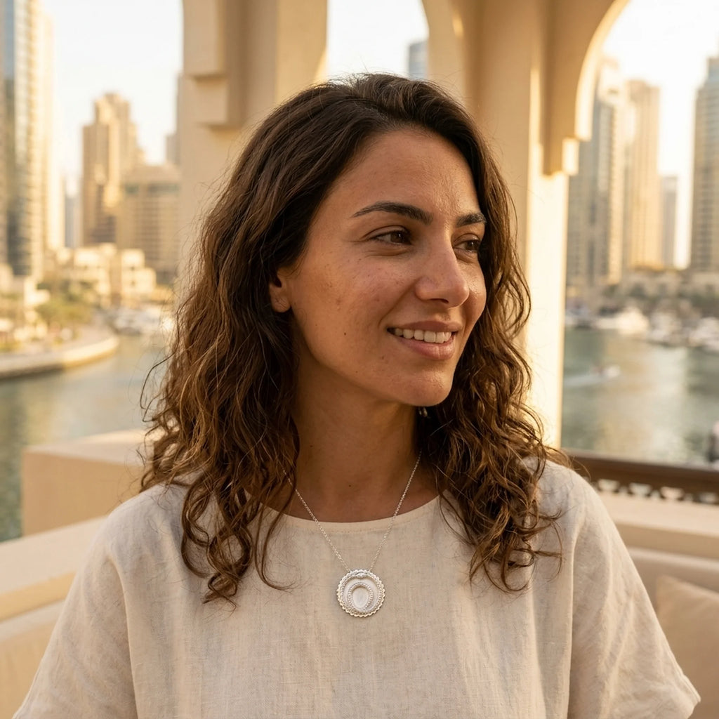 Woman wearing a 925 sterling silver ouroboros snake pendant necklace outdoors in Dubai, a meaningful milestone gift.