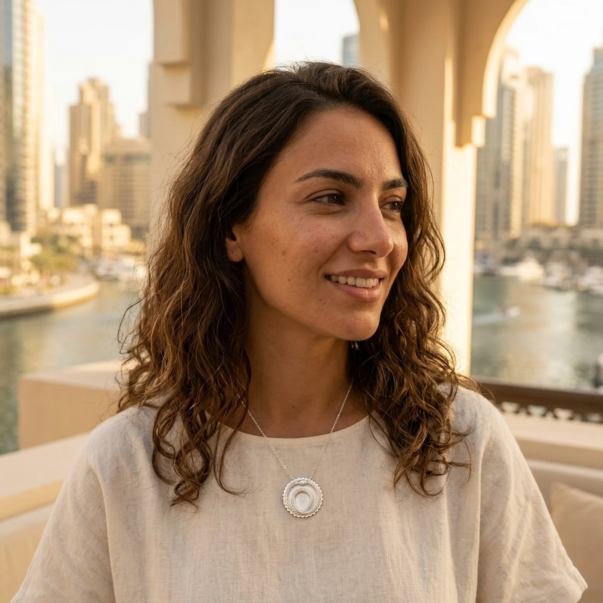 Woman wearing a 925 sterling silver ouroboros snake pendant necklace outdoors in Dubai, a meaningful milestone gift.