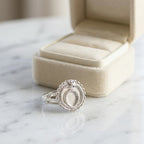 Silver ouroboros snake signet ring in 925 sterling silver with a blue-topaz eye accent by a jewellery box in Dubai.