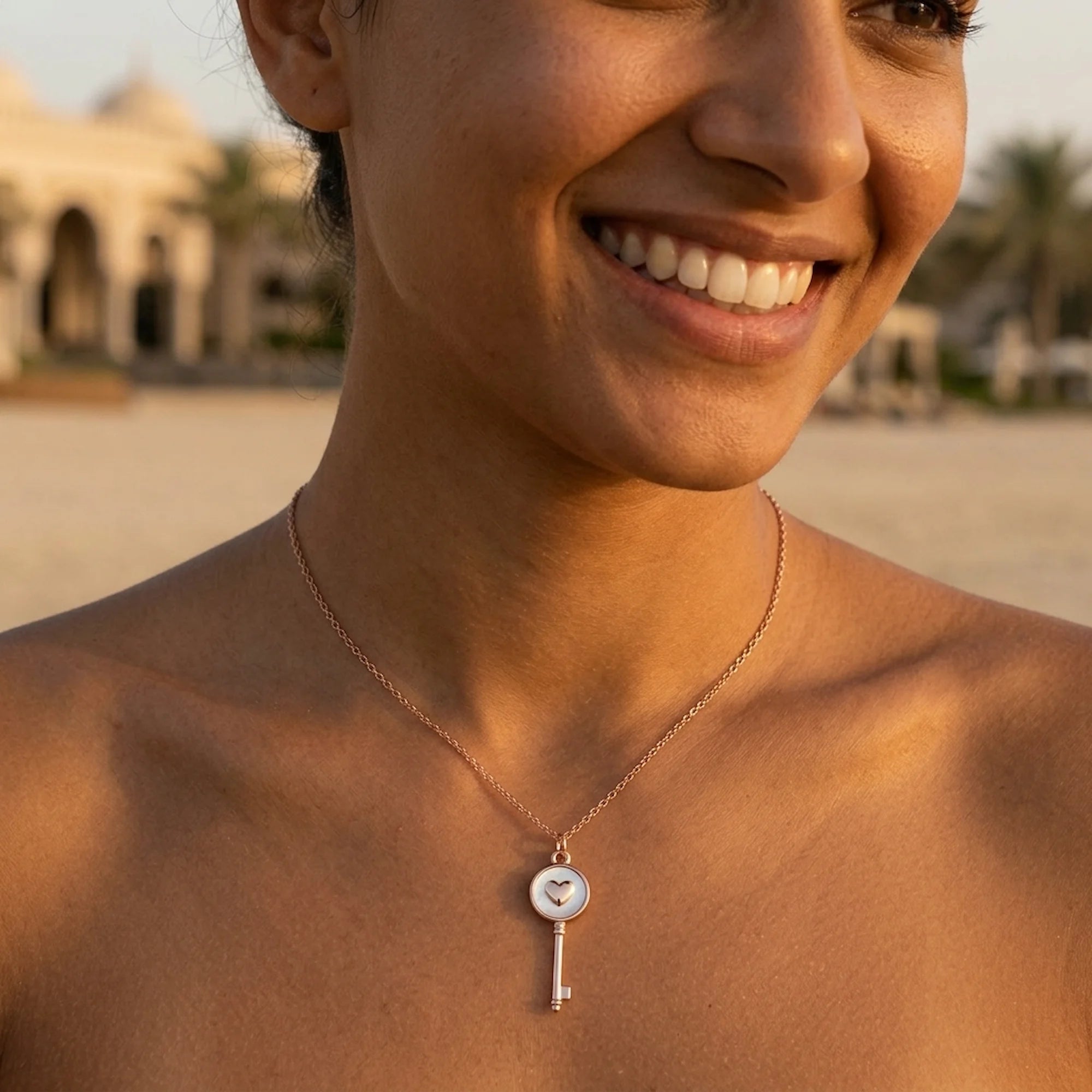 Woman wearing rose gold plated 925 sterling silver heart-and-key pendant necklace outdoors in Dubai.