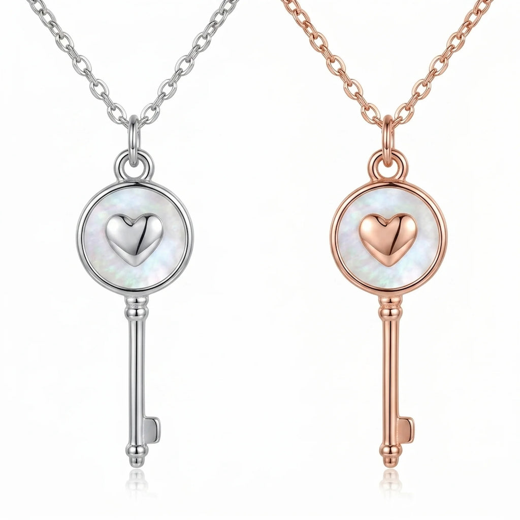 Rhodium and rose gold plated 925 sterling silver heart-and-key pendant necklaces side by side in Dubai.