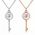 Rhodium and rose gold plated 925 sterling silver heart-and-key pendant necklaces side by side in Dubai.