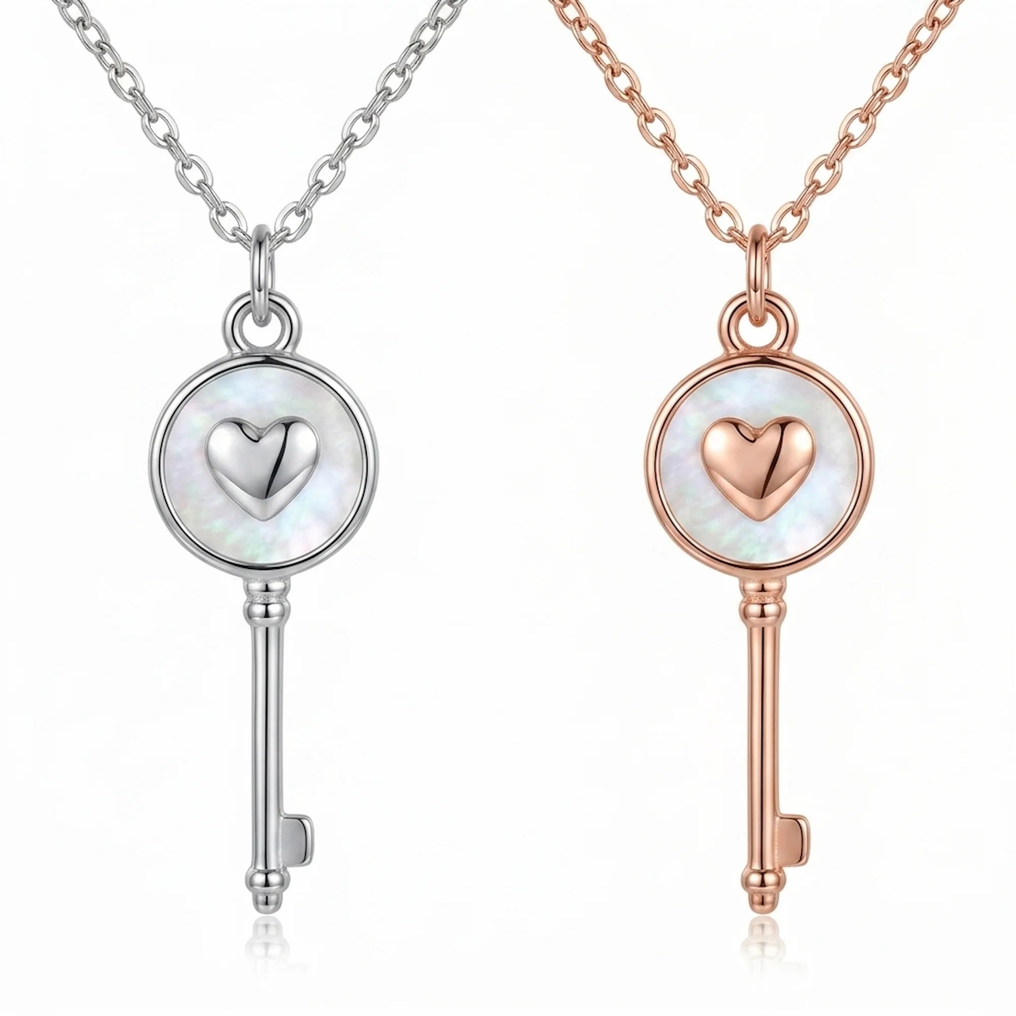 Rhodium and rose gold plated 925 sterling silver heart-and-key pendant necklaces side by side in Dubai.
