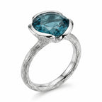 Front view of the 925 sterling silver sky blue topaz lotus cocktail ring with a branch-textured shank in Dubai.