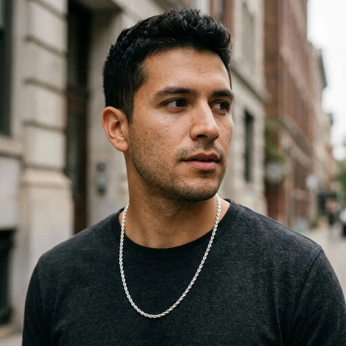 Male model wearing a twisted silver-tone rope-link necklace with a charcoal T-shirt.